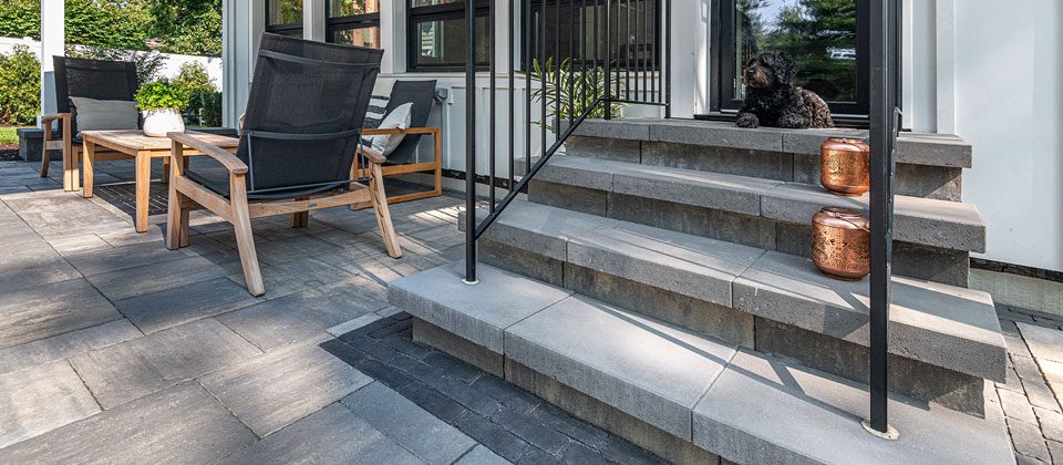 Unilock stone steps connecting to a paved patio